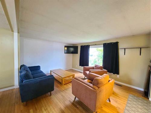 10921 92 Street, Peace River, AB - Indoor Photo Showing Living Room With Fireplace