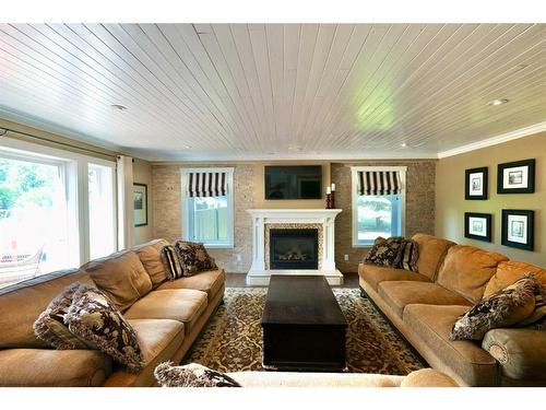 10010 88 Street, Peace River, AB - Indoor Photo Showing Living Room With Fireplace