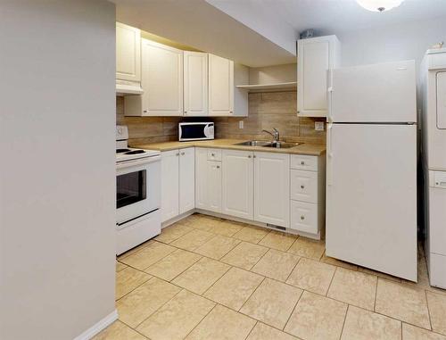 9837 100A Avenue, Sexsmith, AB - Indoor Photo Showing Kitchen With Double Sink