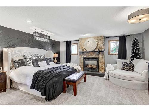 739 Oak Drive, Beaverlodge, AB - Indoor Photo Showing Bedroom With Fireplace