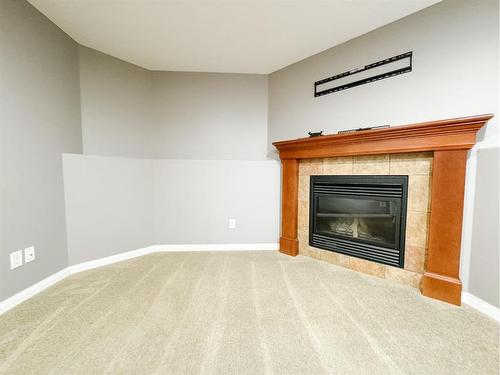 9129 94A Avenue, Grande Prairie, AB - Indoor Photo Showing Living Room With Fireplace