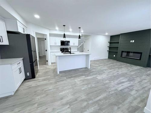 8653 122 Avenue, Grande Prairie, AB - Indoor Photo Showing Kitchen With Fireplace