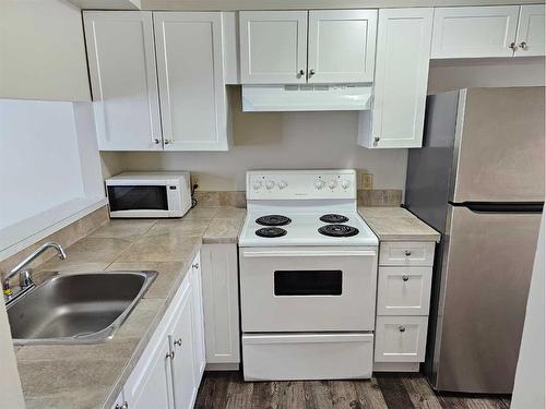 104-9740 82 Avenue, Grande Prairie, AB - Indoor Photo Showing Kitchen With Double Sink