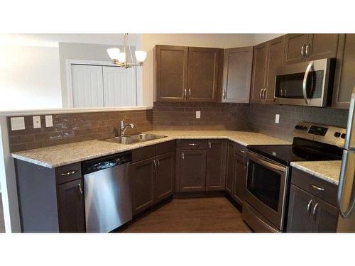 A & B-10217 106 Avenue, Grande Prairie, AB - Indoor Photo Showing Kitchen With Stainless Steel Kitchen With Double Sink