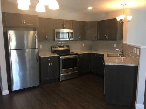 A & B-10217 106 Avenue, Grande Prairie, AB - Indoor Photo Showing Kitchen With Stainless Steel Kitchen With Double Sink