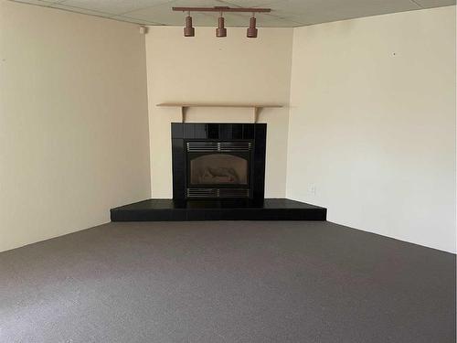 11125 108 Avenue, Fairview, AB - Indoor Photo Showing Living Room With Fireplace