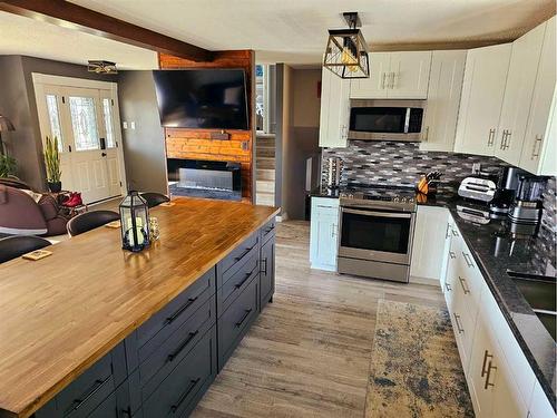 10506 98 Avenue, Grande Cache, AB - Indoor Photo Showing Kitchen With Fireplace With Double Sink