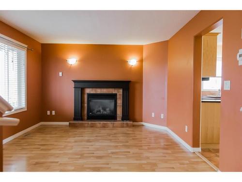 42 Pinnacle Street, Grande Prairie, AB - Indoor Photo Showing Living Room With Fireplace