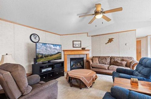 8902 91 Street, Grande Prairie, AB - Indoor Photo Showing Living Room With Fireplace