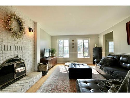 9712 85 Avenue, Peace River, AB - Indoor Photo Showing Living Room With Fireplace