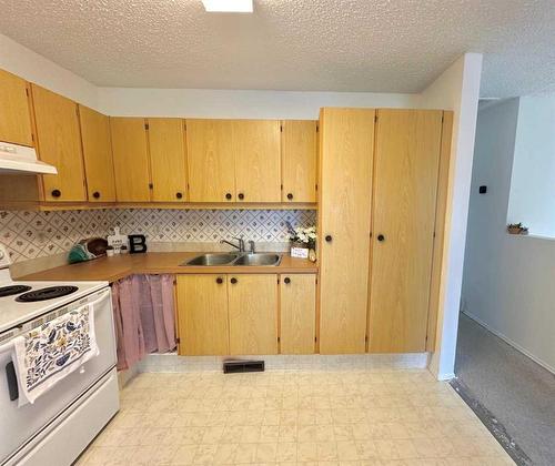 9901 71A Avenue, Grande Prairie, AB - Indoor Photo Showing Kitchen With Double Sink