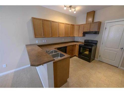 C104-8640 103 Avenue, Grande Prairie, AB - Indoor Photo Showing Kitchen With Double Sink