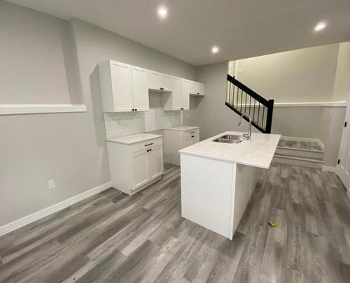 12902 102A Street, Grande Prairie, AB - Indoor Photo Showing Kitchen With Double Sink