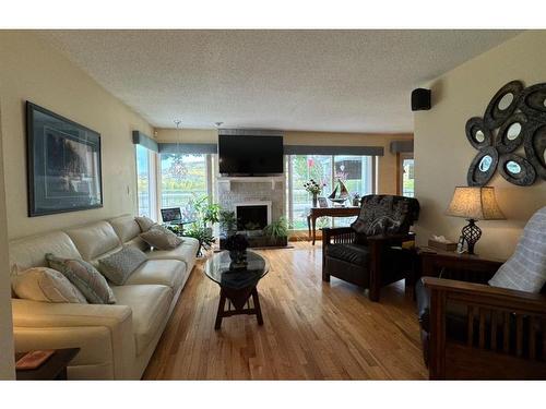 10603 99 Street, Peace River, AB - Indoor Photo Showing Living Room With Fireplace