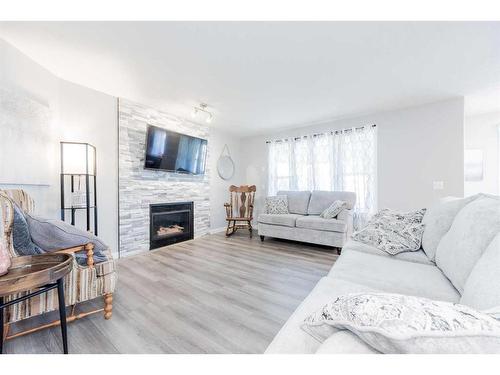 12012 Crystal Lake Drive, Grande Prairie, AB - Indoor Photo Showing Living Room With Fireplace