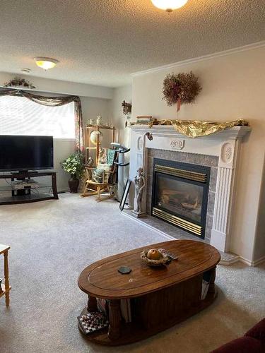 411 1St Street Ne, Manning, AB - Indoor Photo Showing Living Room With Fireplace