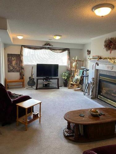 411 1St Street Ne, Manning, AB - Indoor Photo Showing Living Room With Fireplace