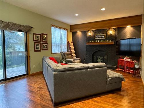 7213 96 Street, Peace River, AB - Indoor Photo Showing Living Room With Fireplace