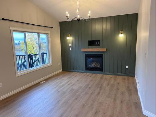 63 Pinnacle Lake Drive, Grande Prairie, AB - Indoor Photo Showing Living Room With Fireplace