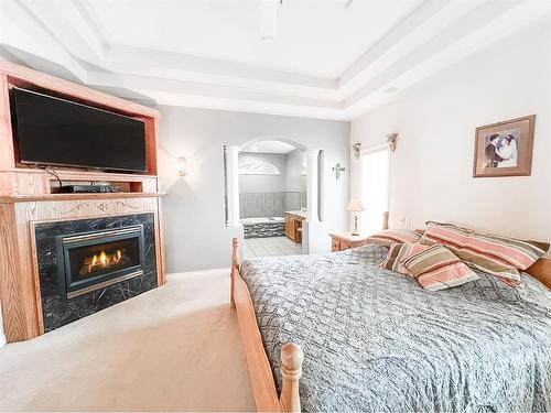 513 1St B Street Sw, Falher, AB - Indoor Photo Showing Bedroom With Fireplace