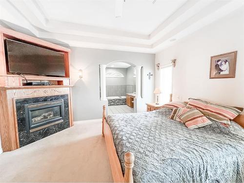 513 1St B Street Sw, Falher, AB - Indoor Photo Showing Bedroom With Fireplace