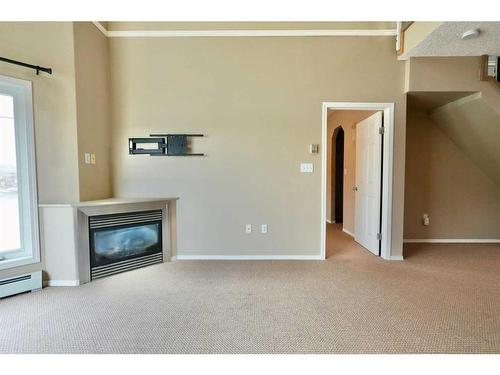 404-9810 94 Street, Peace River, AB - Indoor Photo Showing Living Room With Fireplace