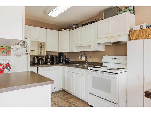 109-7014 100 Street, Grande Prairie, AB - Indoor Photo Showing Kitchen With Double Sink