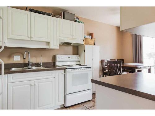 109-7014 100 Street, Grande Prairie, AB - Indoor Photo Showing Kitchen With Double Sink