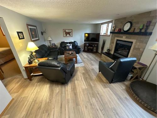 7129 99A Street, Peace River, AB - Indoor Photo Showing Living Room With Fireplace