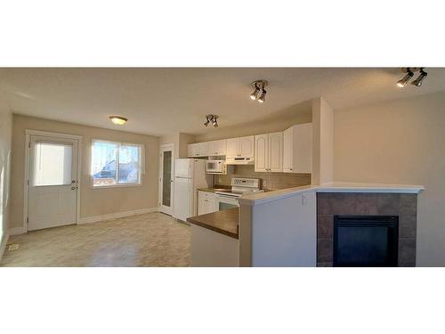 198 Pinnacle Way, Grande Prairie, AB - Indoor Photo Showing Other Room With Fireplace