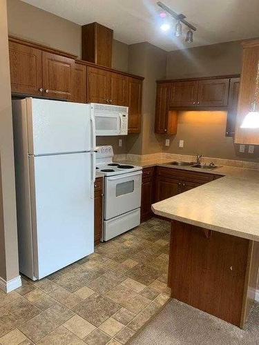 401-9225 Lakeland Drive, Grande Prairie, AB - Indoor Photo Showing Kitchen With Double Sink