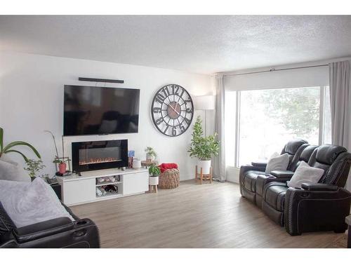 8618 99B Street, Grande Prairie, AB - Indoor Photo Showing Living Room With Fireplace