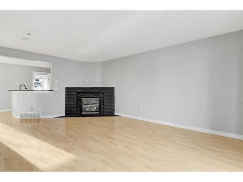 18 Pinnacle Avenue, Grande Prairie, AB - Indoor Photo Showing Living Room With Fireplace