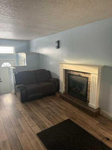 11250 75A Avenue, Grande Prairie, AB - Indoor Photo Showing Living Room With Fireplace