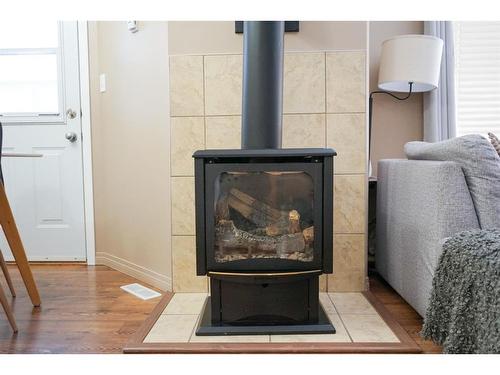 231-10150 121 Avenue, Grande Prairie, AB - Indoor Photo Showing Living Room With Fireplace