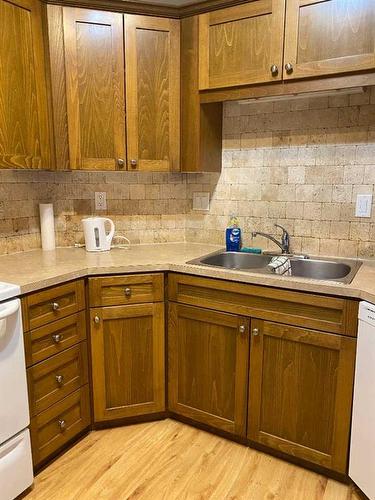 103-9229 Lakeland Drive, Grande Prairie, AB - Indoor Photo Showing Kitchen With Double Sink