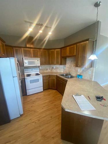 103-9229 Lakeland Drive, Grande Prairie, AB - Indoor Photo Showing Kitchen With Double Sink