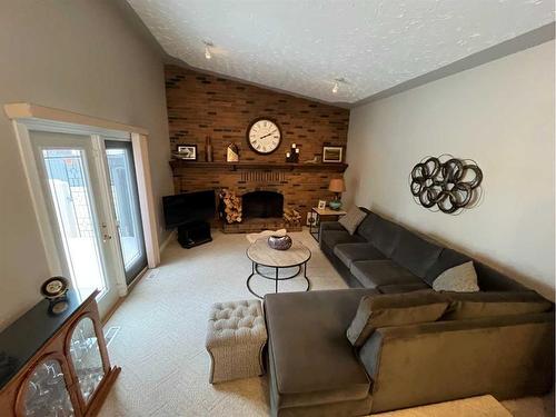 7909 94 Street, Peace River, AB - Indoor Photo Showing Living Room With Fireplace