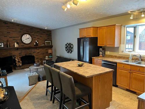 7909 94 Street, Peace River, AB - Indoor Photo Showing Kitchen With Fireplace With Double Sink