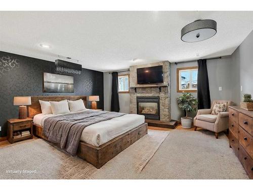 739 Oak Drive, Beaverlodge, AB - Indoor Photo Showing Bedroom With Fireplace