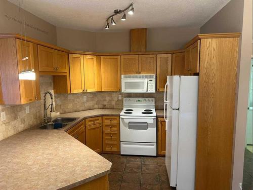 206-9225 Lakeland Drive, Grande Prairie, AB - Indoor Photo Showing Kitchen With Double Sink