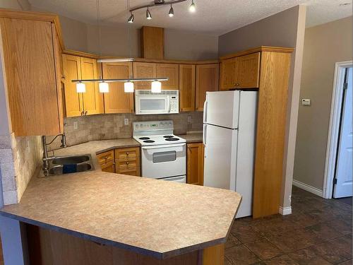 206-9225 Lakeland Drive, Grande Prairie, AB - Indoor Photo Showing Kitchen With Double Sink