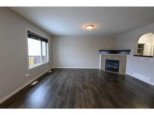 8545 102A Avenue, Grande Prairie, AB - Indoor Photo Showing Living Room With Fireplace