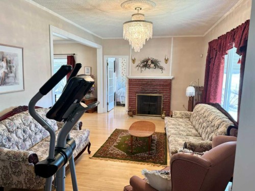 103 Centre Street, Mclennan, AB - Indoor Photo Showing Living Room With Fireplace