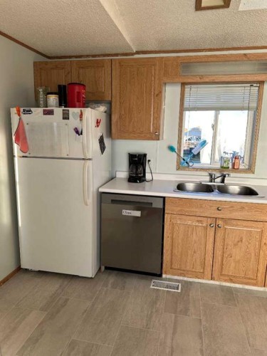 9702 108A Avenue, Clairmont, AB - Indoor Photo Showing Kitchen With Double Sink