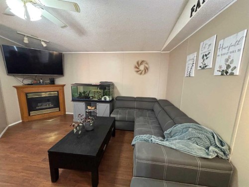 9702 108A Avenue, Clairmont, AB - Indoor Photo Showing Living Room With Fireplace