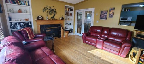 4601 50 Avenue, Grimshaw, AB - Indoor Photo Showing Living Room With Fireplace