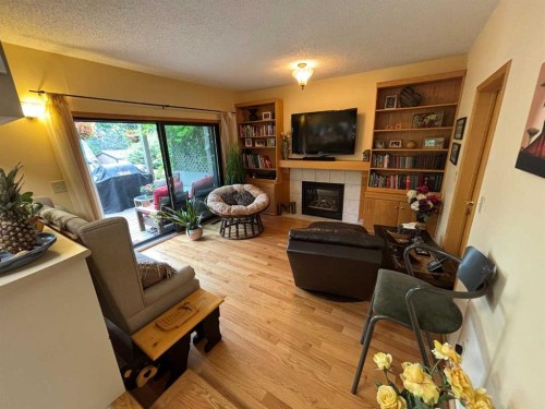 9602 71 Avenue, Peace River, AB - Indoor Photo Showing Living Room With Fireplace