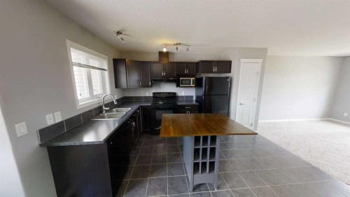 129-9105 91 Street, Grande Prairie, AB - Indoor Photo Showing Kitchen With Double Sink
