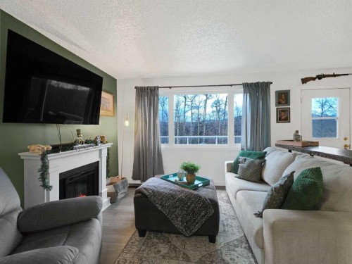 47 97 Avenue, Grande Cache, AB - Indoor Photo Showing Living Room With Fireplace